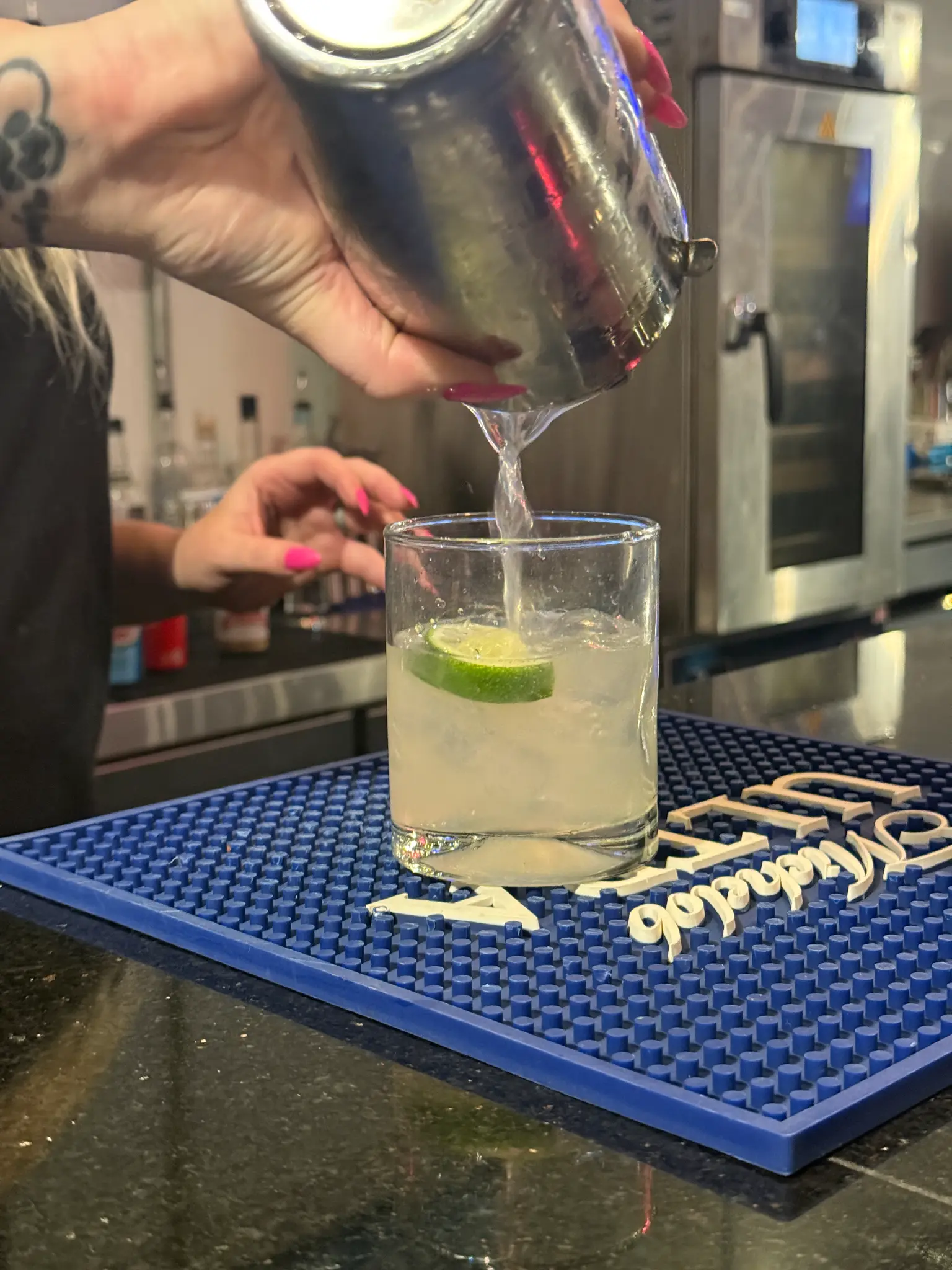 Bartender pouring a cocktail