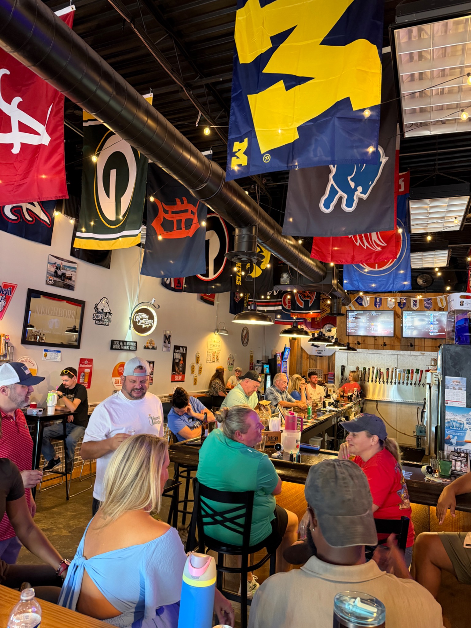 Guests enjoying a busy evening around the bar at Neighbors
